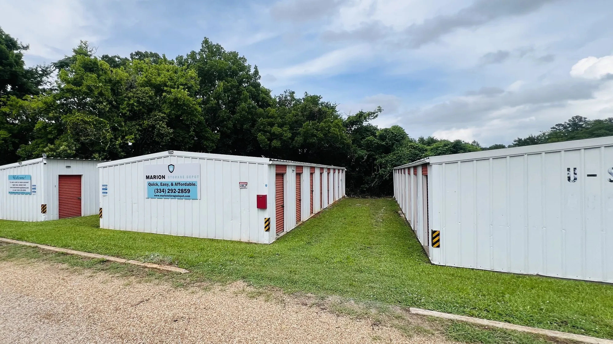 Marion Storage Depot Pickens St facility: white storage buildings with red roll-up doors and the facility sign board